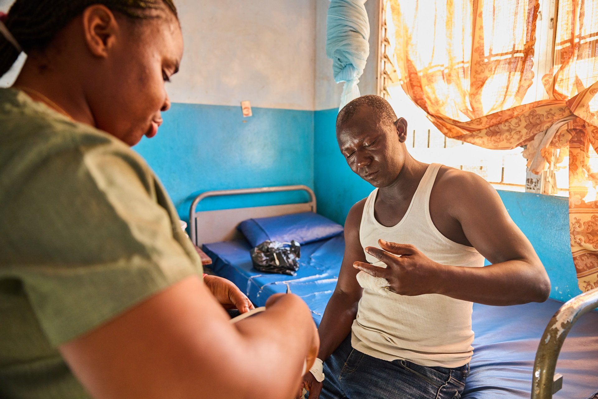 A nurse and a patient admitted for skin-related NTDs in a district health center in sub-Saharan Africa